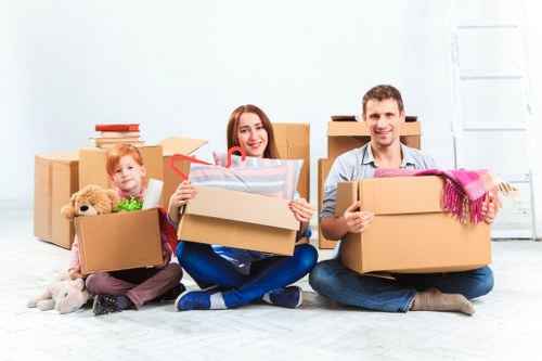 Removal team preparing a move in South Kensington with packed boxes and furniture protection