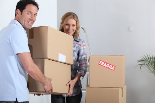 Movers carrying boxed belongings into a new South Kensington home